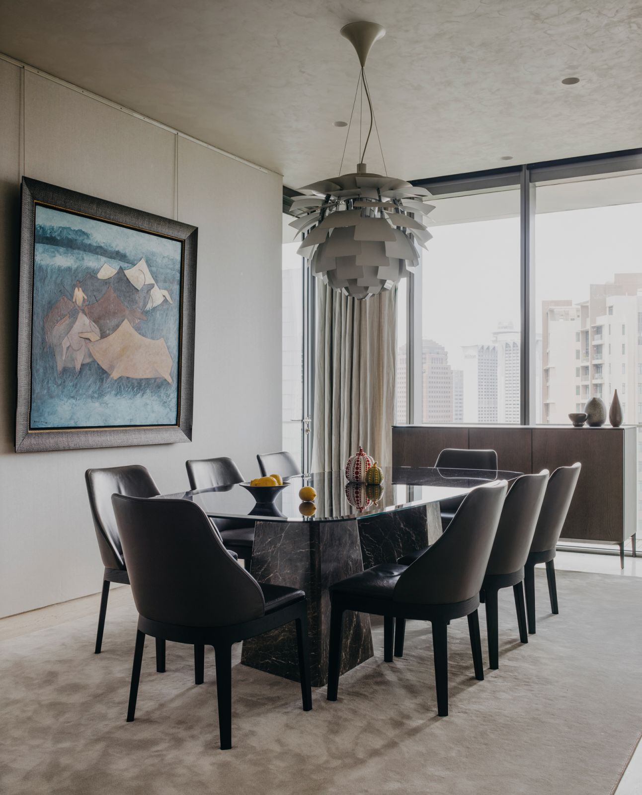 The stylish dining area brings together an interesting array of materials and forms