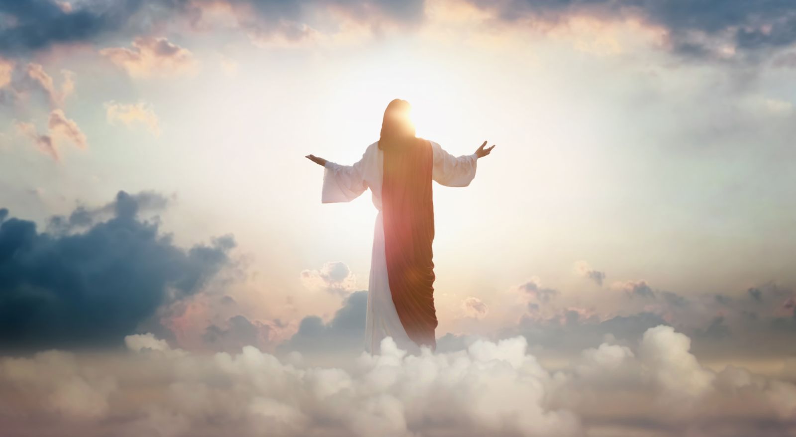 The resurrected Jesus Christ ascending to heaven above the bright light sky and clouds and God, Heaven and Second Coming concept