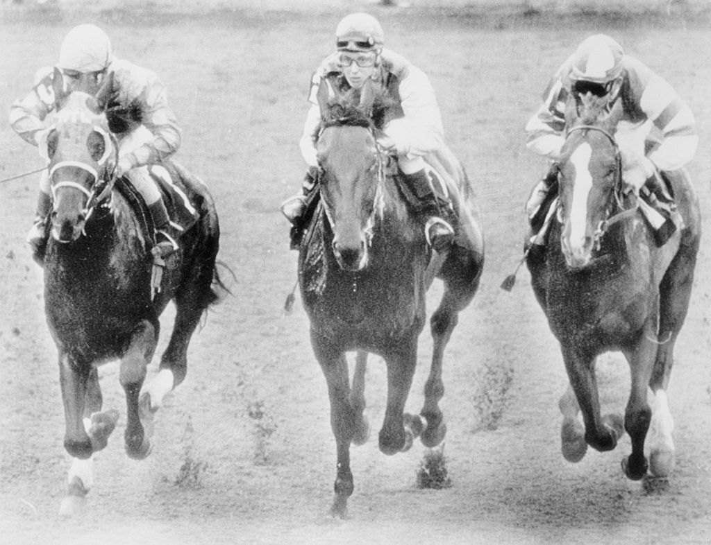 (Original Caption) Riding "Bridle 'N Bit", Diane Crump (center) keeps right up with Mike Sorentino (left), who's on "Born In A Trunk", an Craig Perret, on "Shir-Tee", during the seventh race at Hialeah February 7th. Diane, 20, became the first woman to compete in a regular event in U.S. thoroughbred racing history. She finished tenth in a field of twelve.