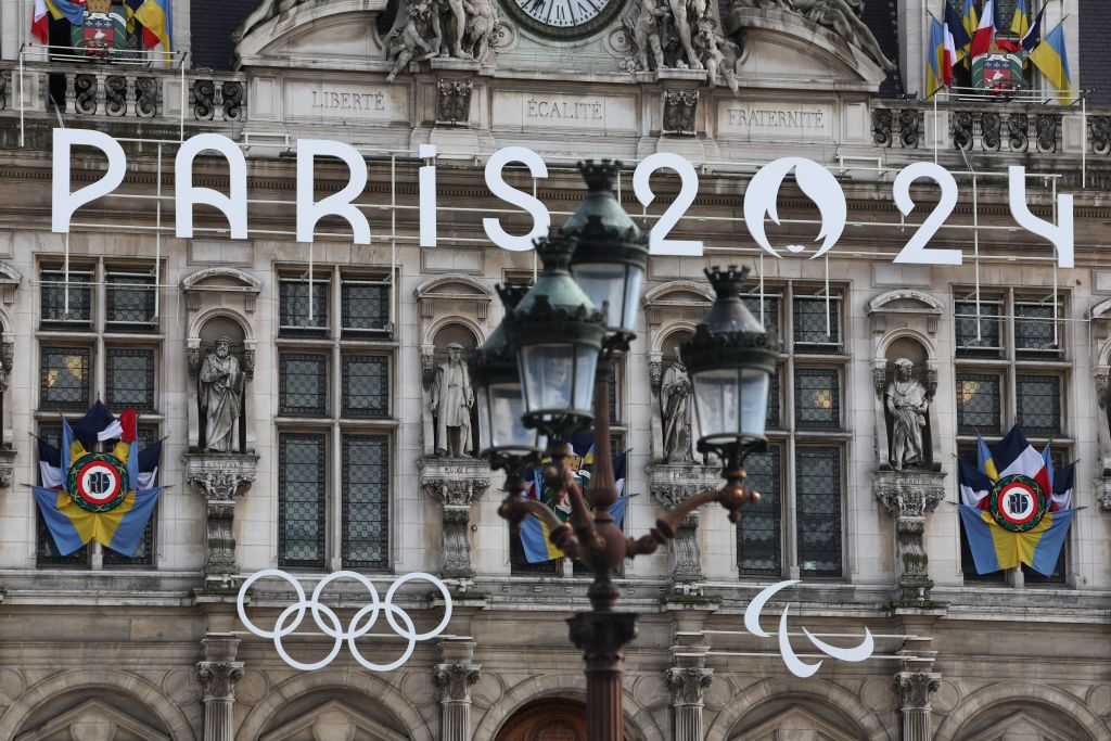 PARIS, FRANCE - MARCH 14: The Paris 2024 logo, representing the Olympic and Paralympic Games four months prior to the start of the Paris 2024 Olympic and Paralympic games is displayed on the facade of Paris town hall on March 14, 2024 in Paris, France. The city is gearing up to host the XXXIII Olympic and Paralympic Summer Games, from 26 July to 11 August. (Photo by Pascal Le Segretain/Getty Images)
