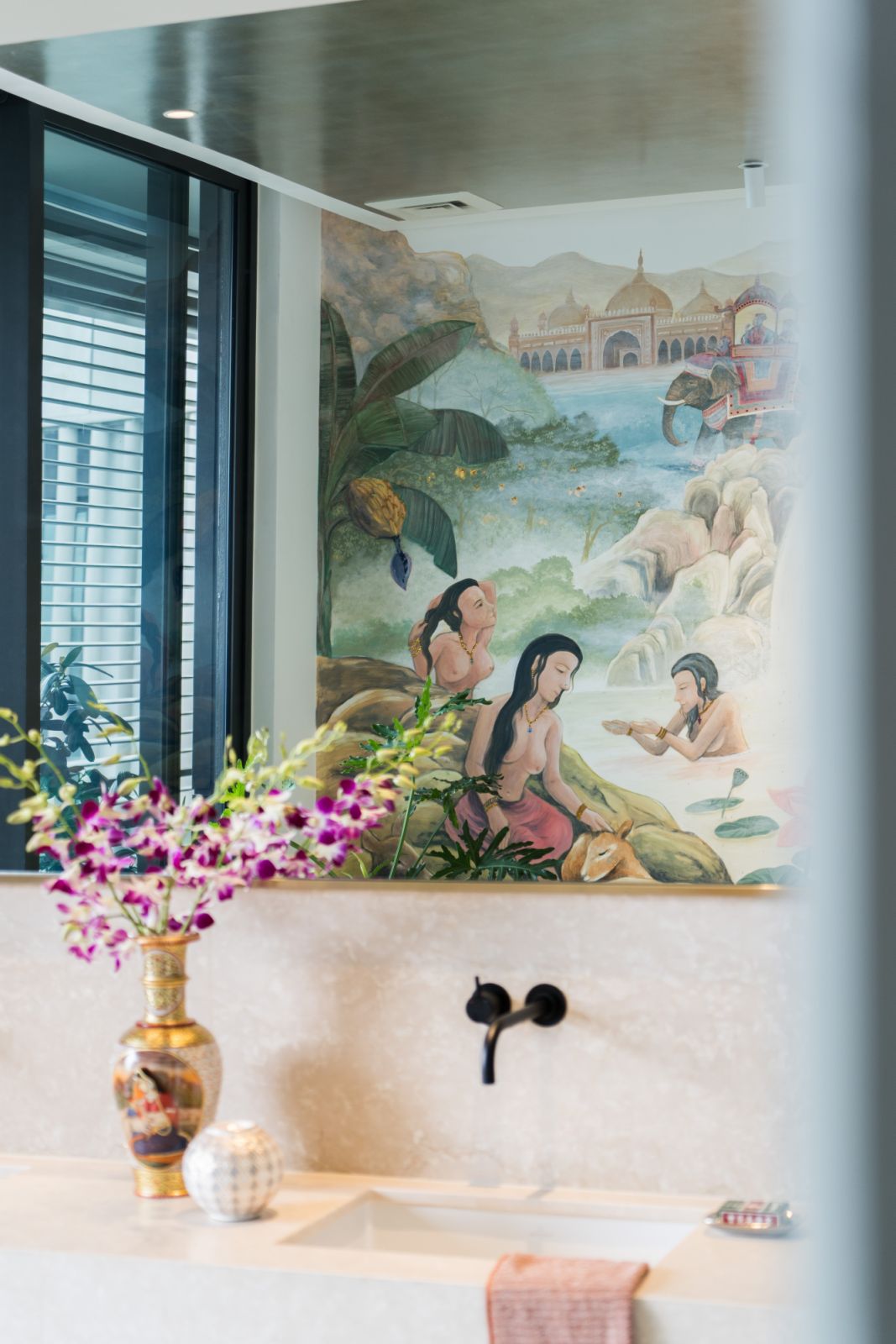The master bathroom features a commisioned mural of ‘Bathing Ladies’ depicting royalty and court ladies from a palace in India, bathing leisurely in a private lake away from prying eyes