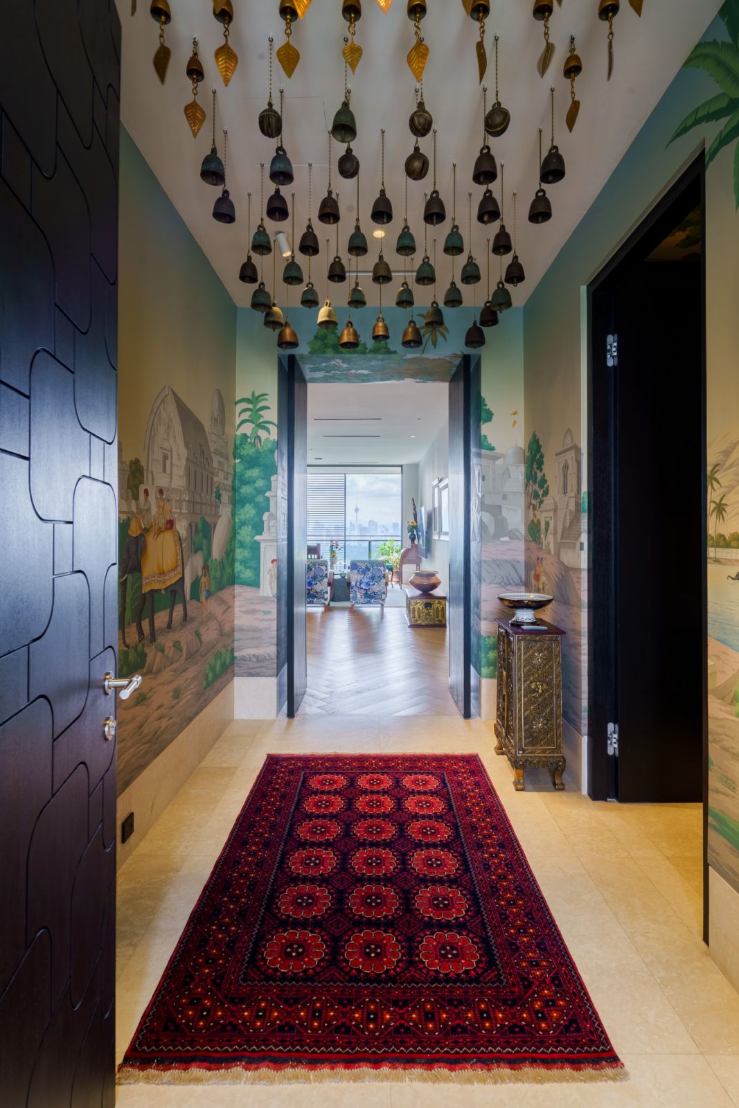 The entry foyer with carefully grouped and curates bells arranged  from India, Burma to Thailand are arranged in  descending order
