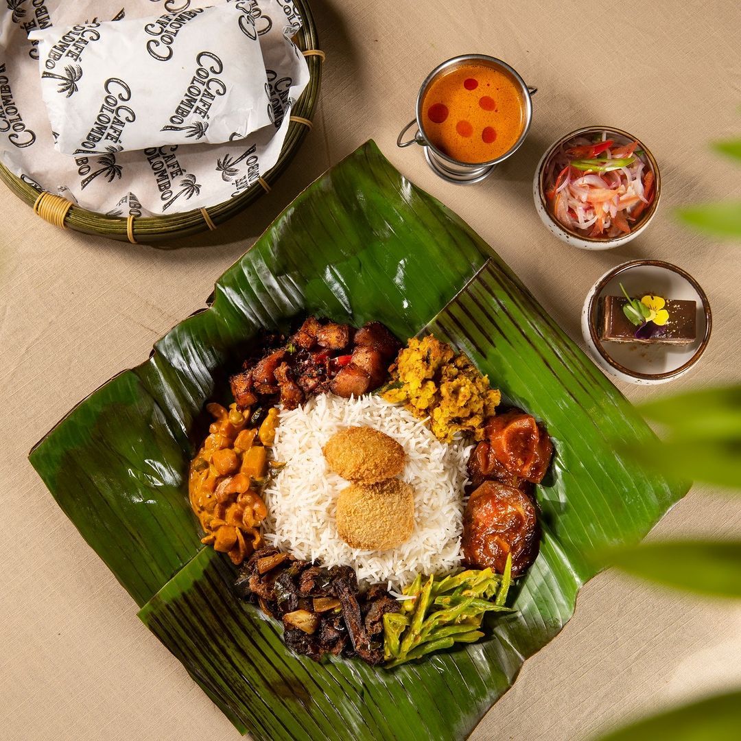 Bath mula with cashew curry, mango curry, and dal (Photo: Instagram / @cafecolombomy)