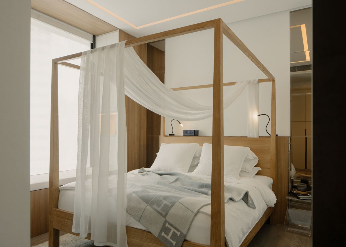a four-poster bed lends a romantic touch
