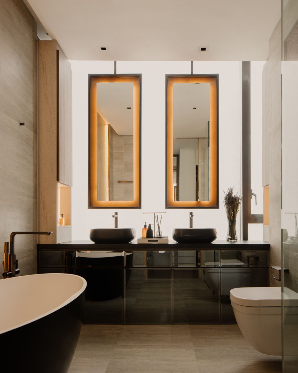 Softly lit mirrors create a spa-like feel in the bathroom