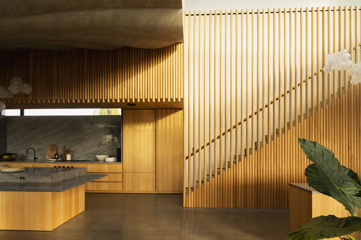 The dramatic shadow on the textured wall of the kitchen
