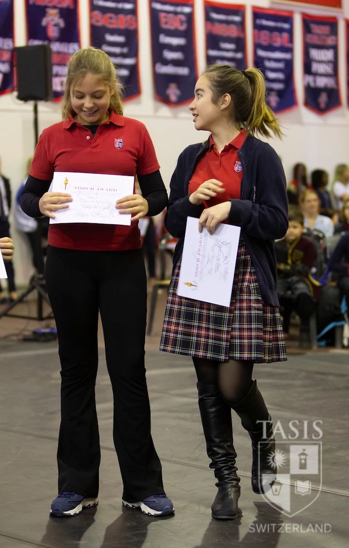 Mira receiving the Torch Award, which recognises one student per grade and highlights their openness and appreciation for cultures different to their own