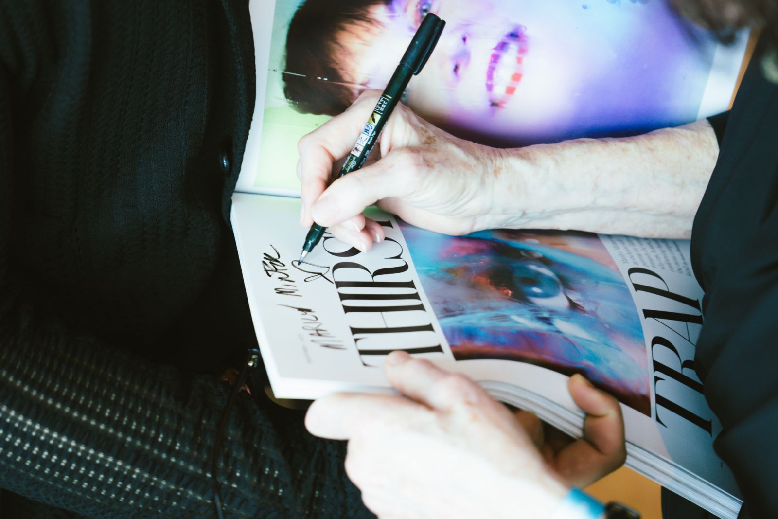 Minter signs her article in Tatler's March issue for fans