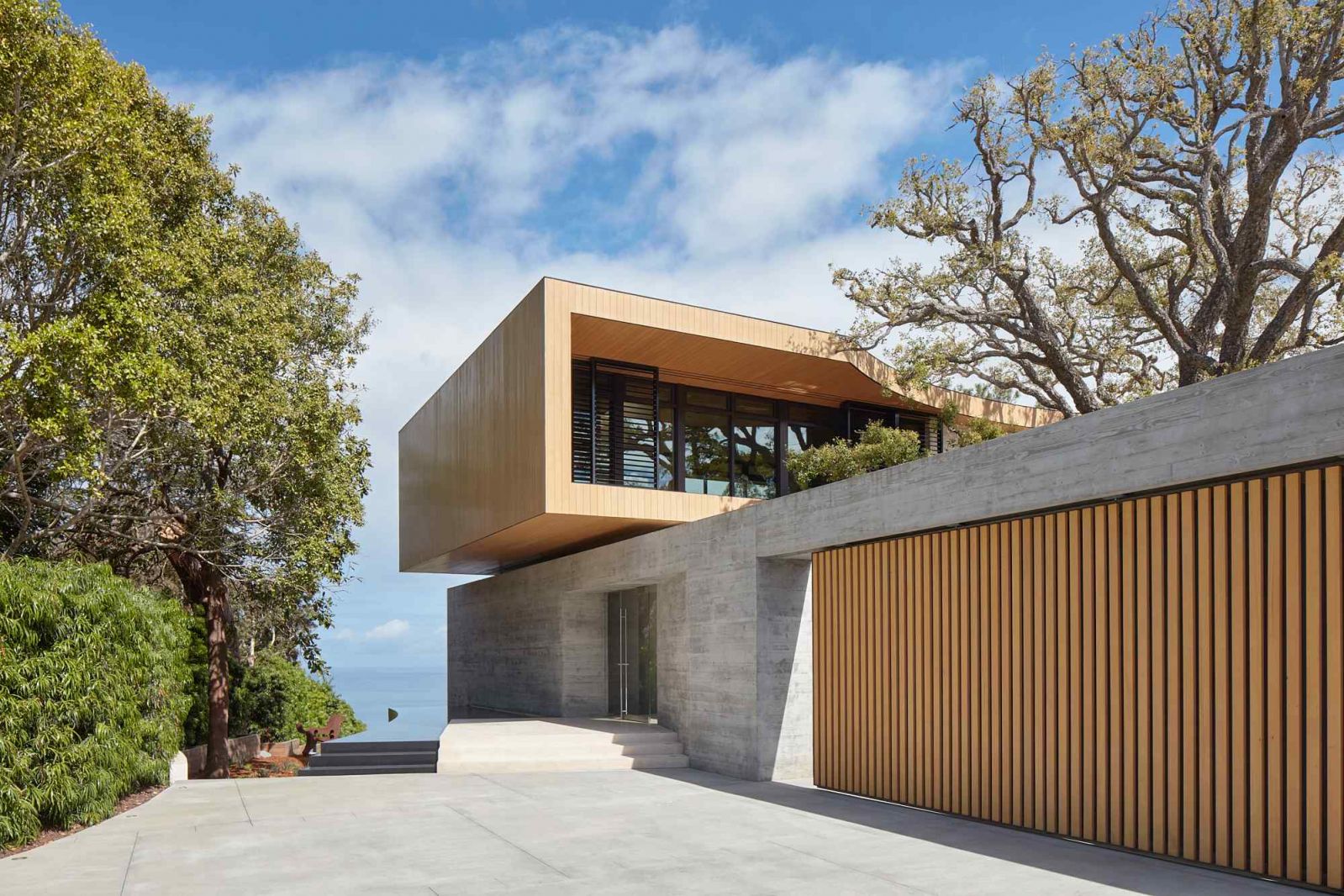The elongated cedar-clad box captures the eye upon entry into the site