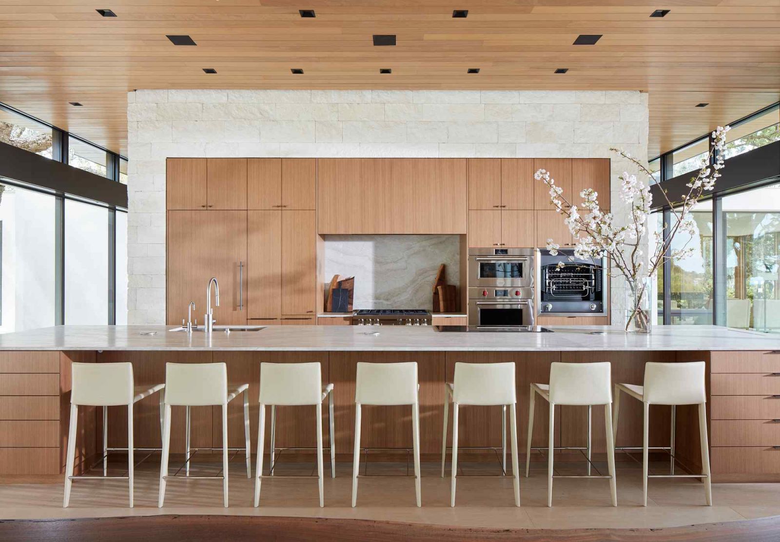 The kitchen with limestone floors and wood ceilings with clear stain finishing