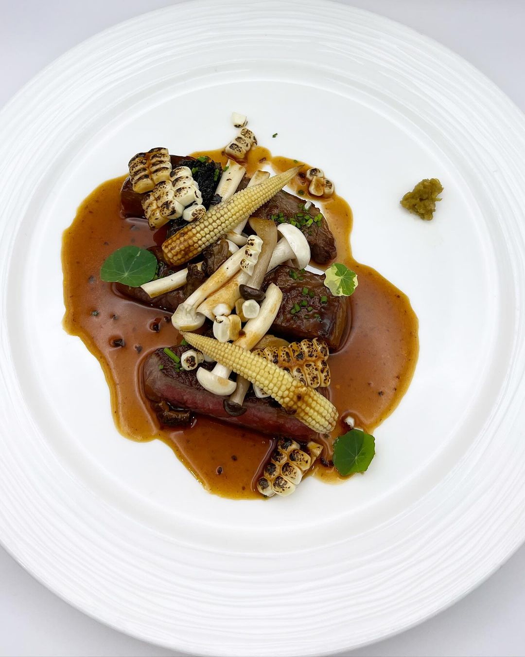 Grilled Wagyu beef, black garlic sauce, and torched Chitose corn (Photo: Instagram / @sage.restaurantandwinebar)