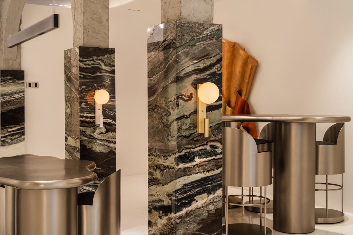 Graphic marble lends visual weight to the interior of the Sol Luminaire Gallery