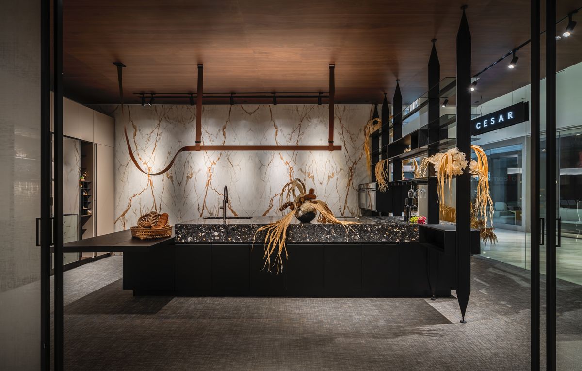 A stately marble Poggenpohl kitchen island greets customers as they walk in