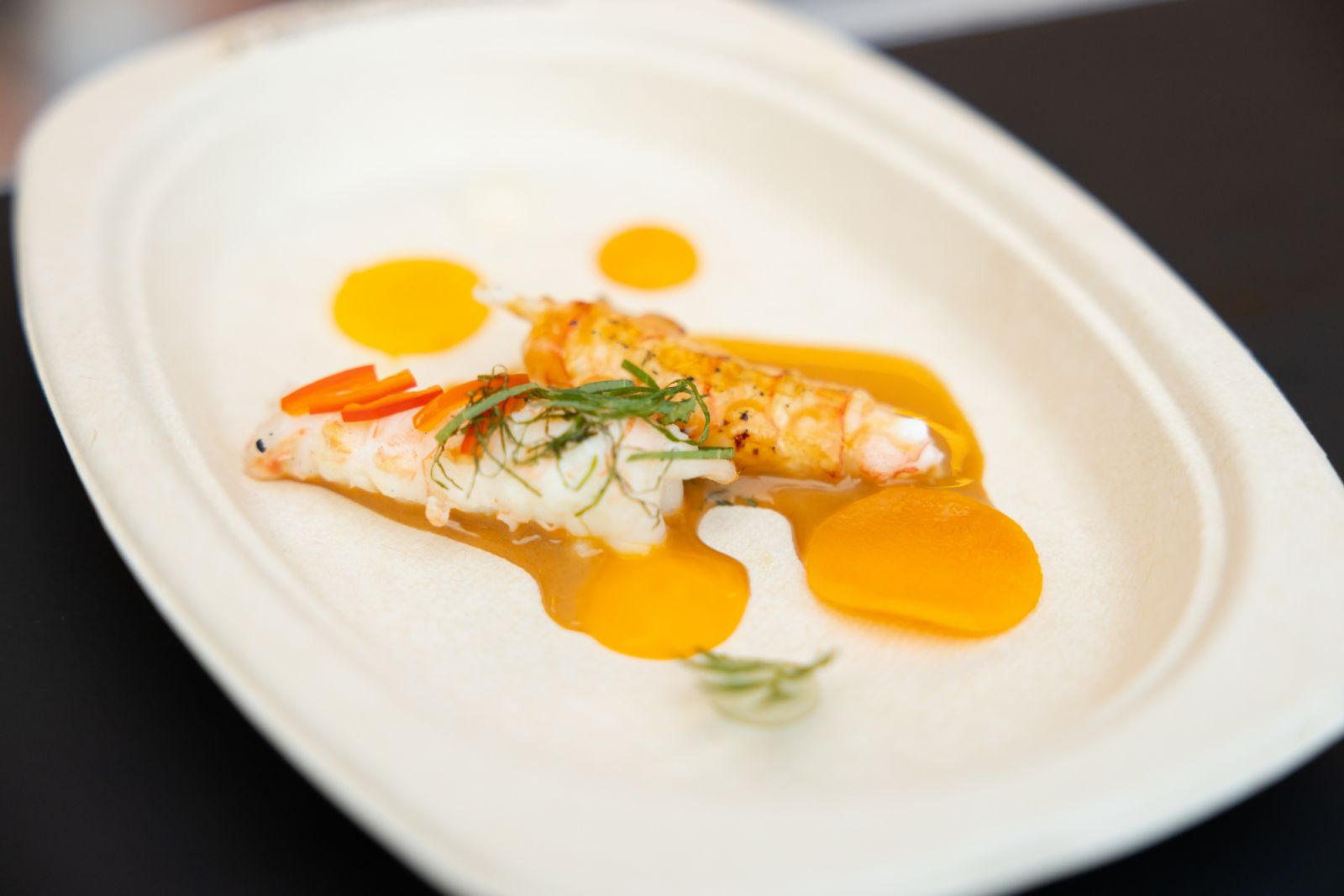 Grilled langoustine tails over binchotan charcoal, lemon verbena and nantua sauce จาก Le Normandie by Alain Roux