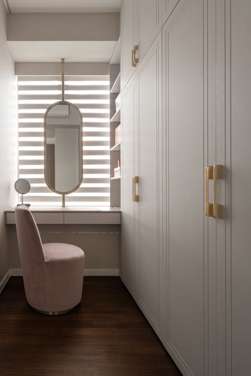 A curvy pink swivel chair is the perfect accompanying piece in the dressing area