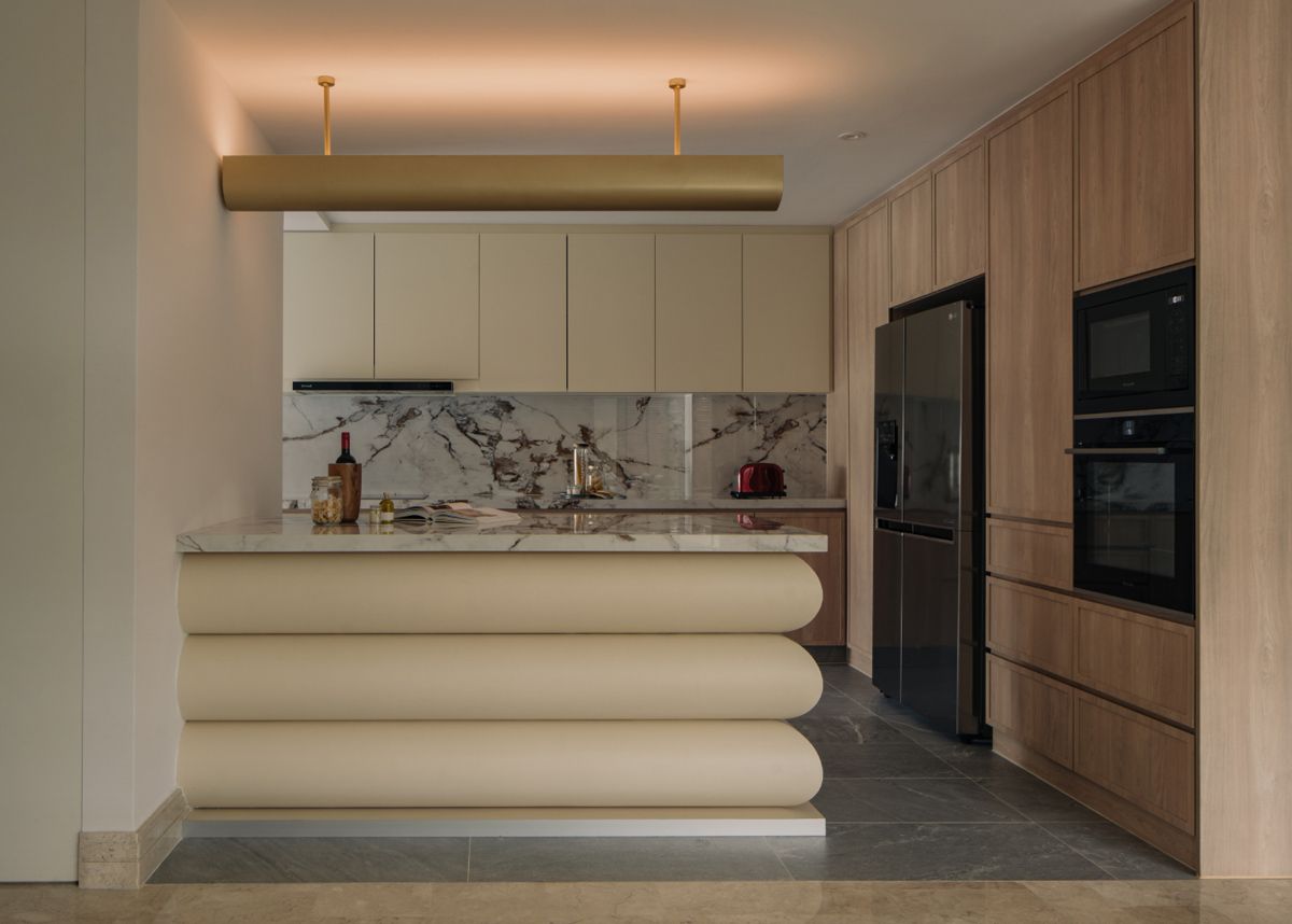 The kitchen island features a tiered base reminiscent of pastries and other sweet treats