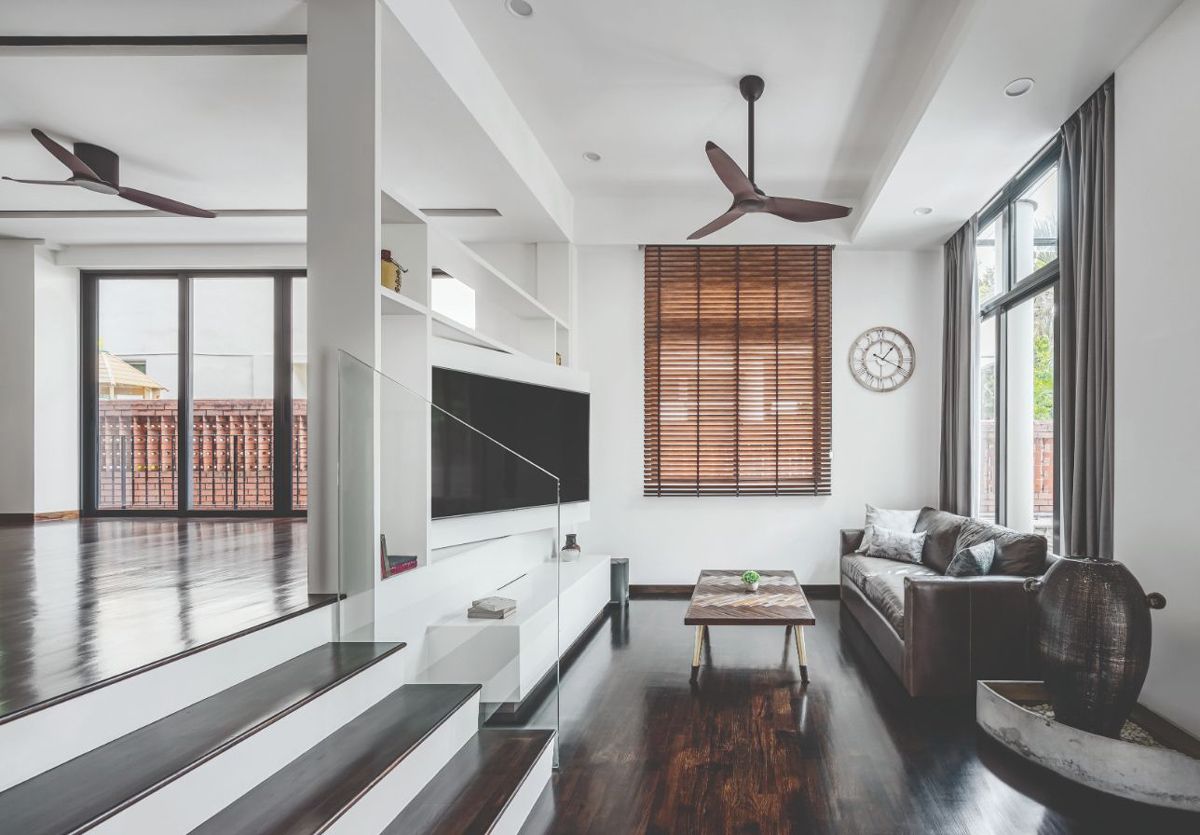 The furnishings were selected to match the dark tones of the stained wood flooring