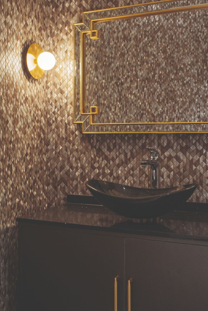 Glimmering mosaic tiles up the glamour quotient of the powder room