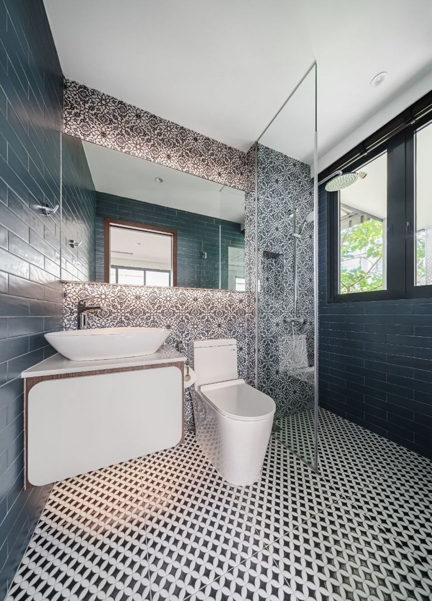 The teal blue walls and mosaic tiles add visual interest to the powder room
