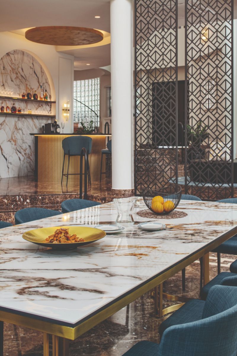 The luxurious use of marble adds pizzazz to the bar area and dining room
