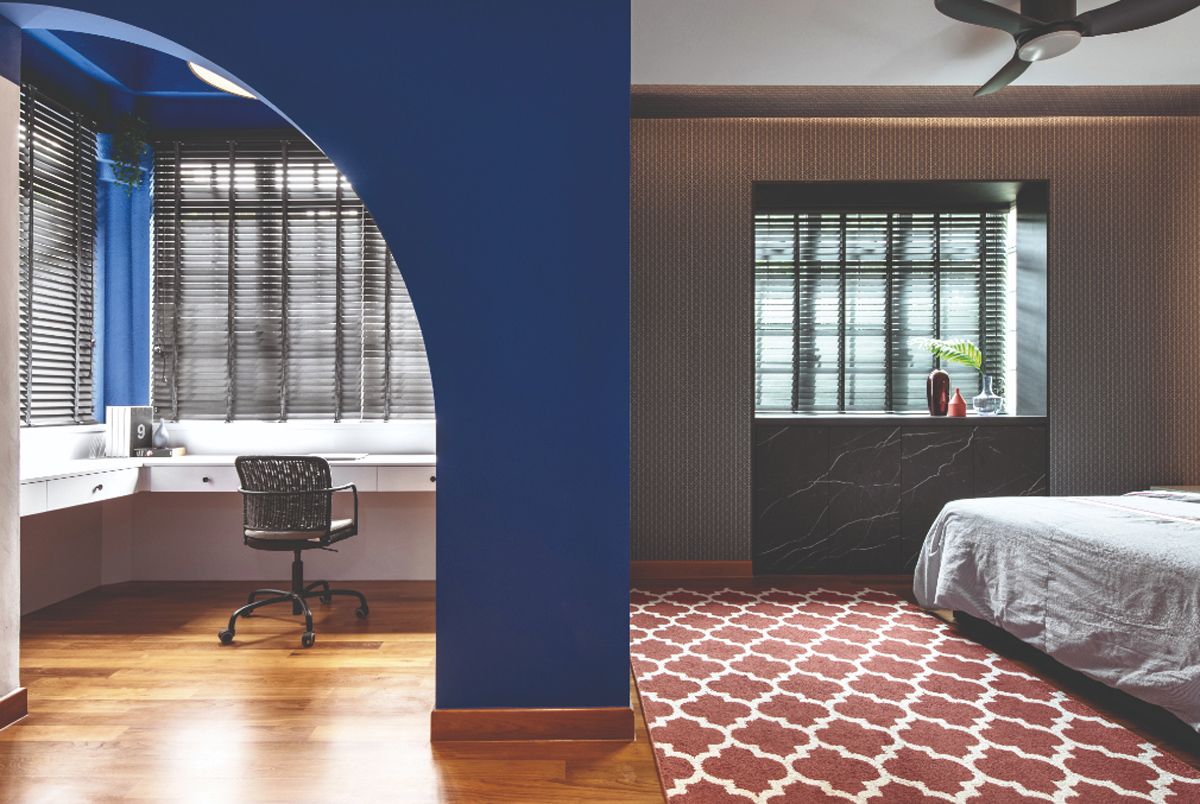 Blue walls help to define this space and demarcate the study from the sleeping area