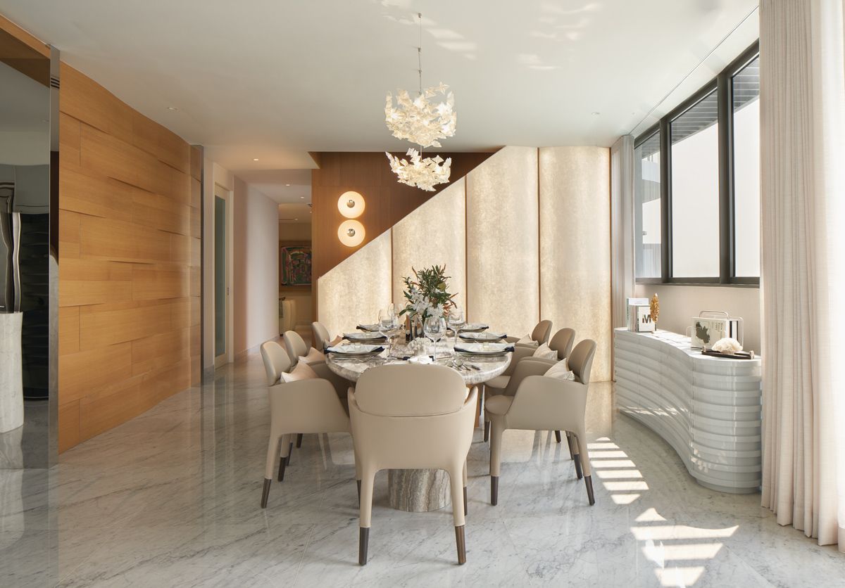 Illuminated wall panels create a striking backdrop in the elegant dining area