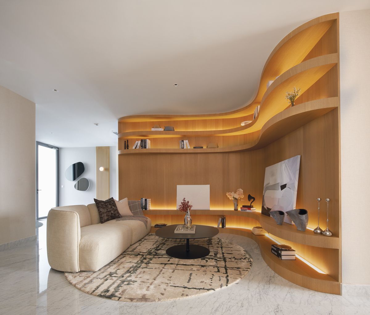 The family room features display shelves with undulating curves that reference the movement of the waves