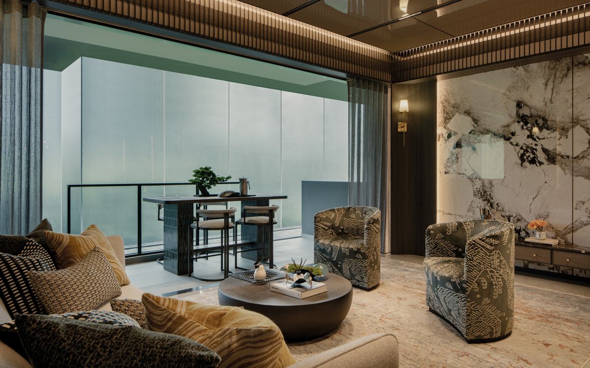 The balcony area near the living room is maximised with a table and chairs for recreational activities or informal meals