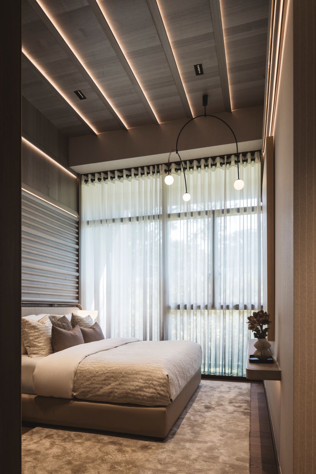 Taupe tones and the use of light wood contribute to the calming atmosphere of this bedroom
