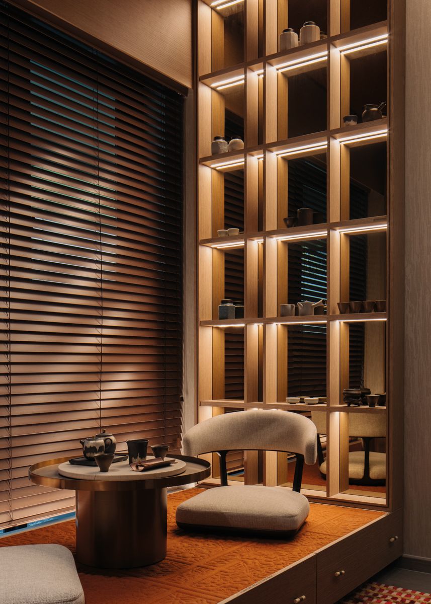 Backlit traditional Japanese shelves cast enchanting shadows on the blinds in the tea room