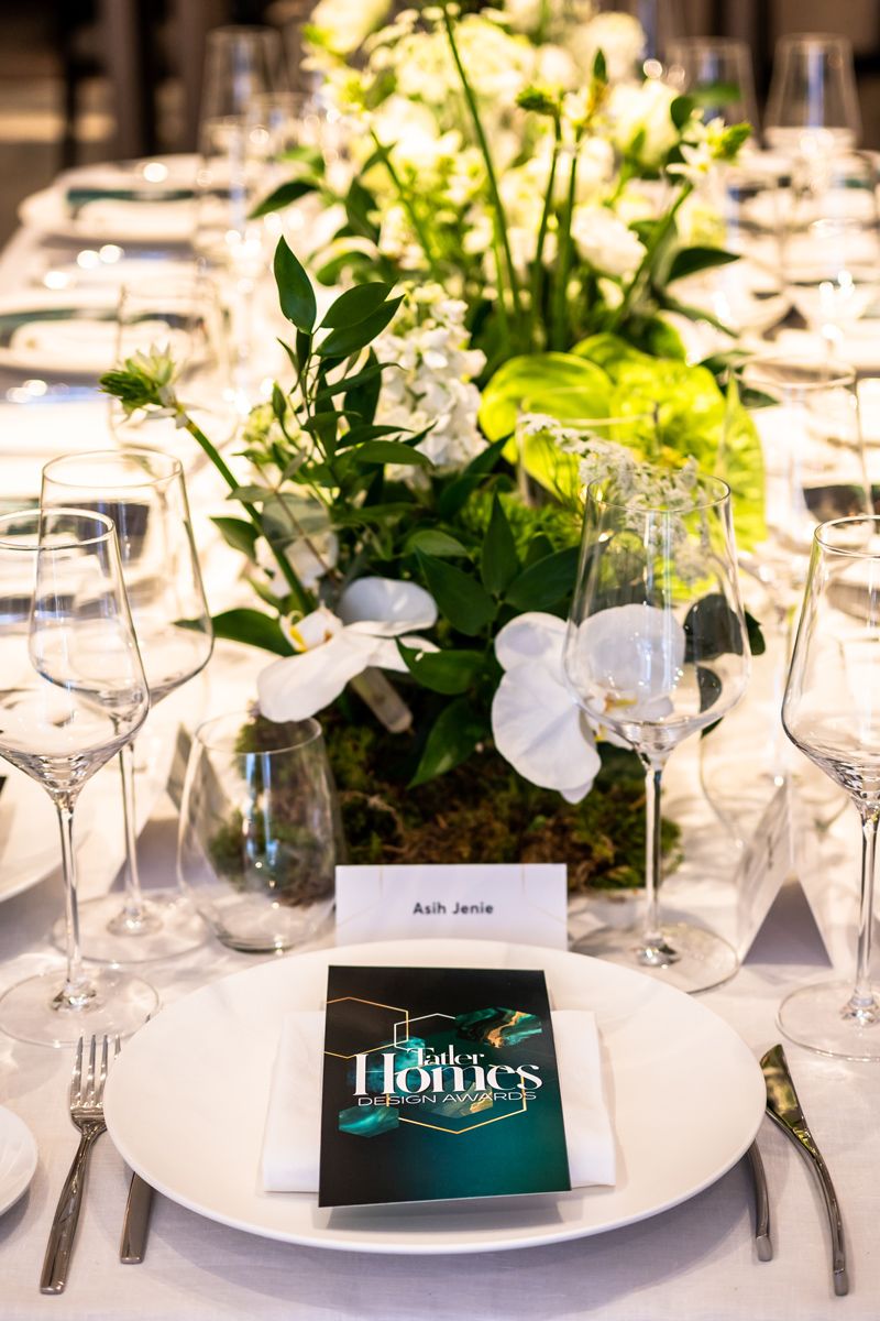Phalaenopsis orchids and chartreuse anthurium lend colour to the table setting
