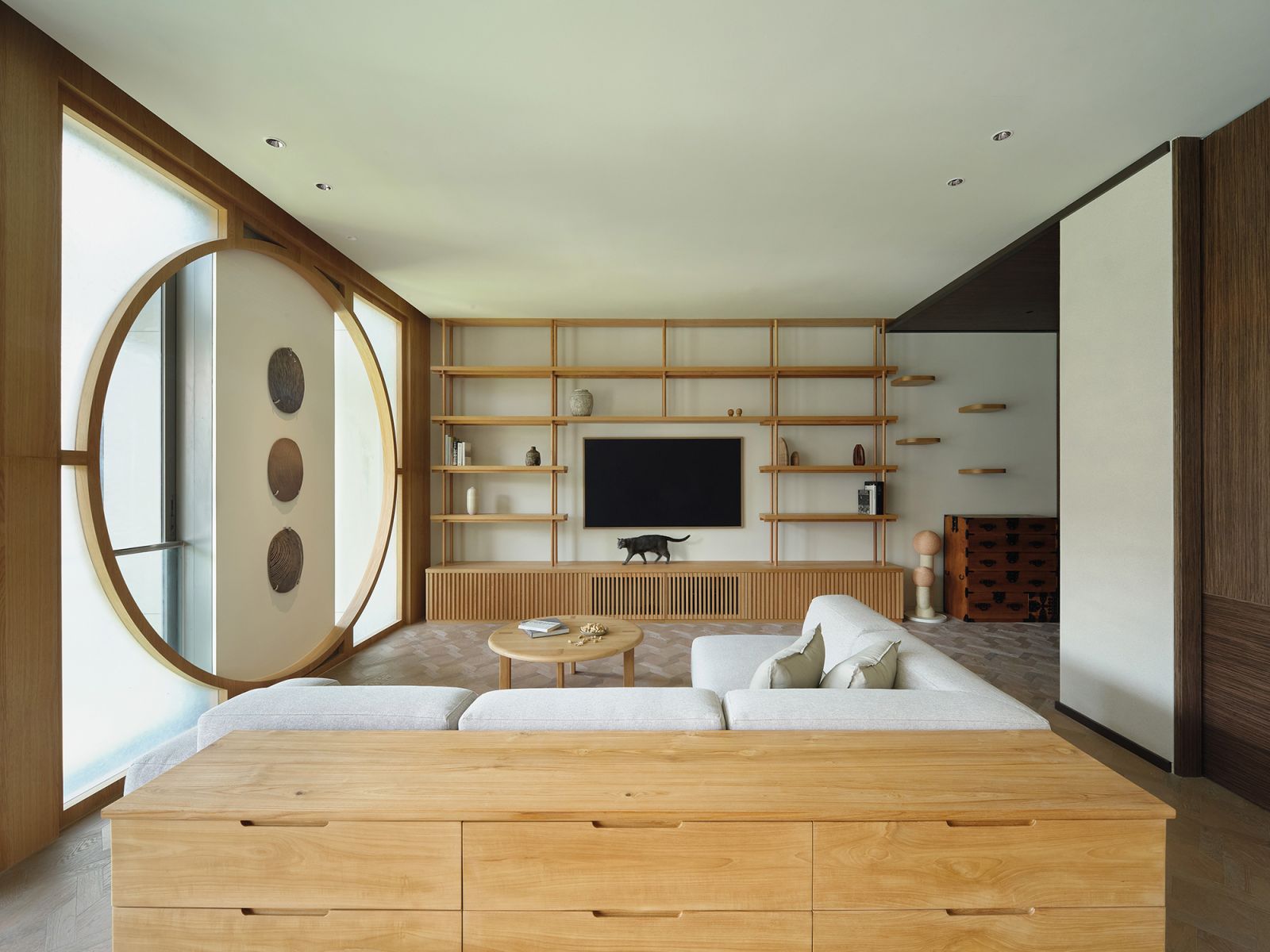 Additions in pale wood balance out the darker material palette of the apartment’s original interior