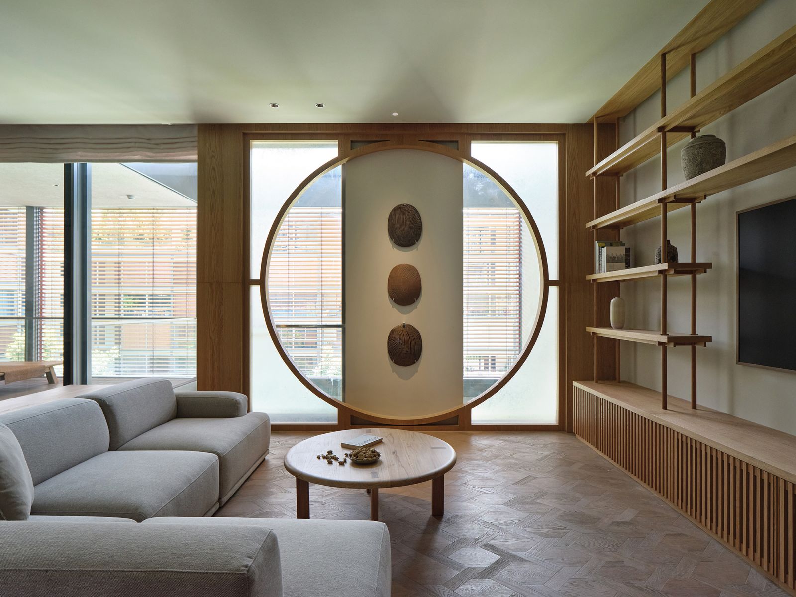 Inspired by moon gates, this circular window articulation gives the interior a soft glow with its light-diffusing paper finish