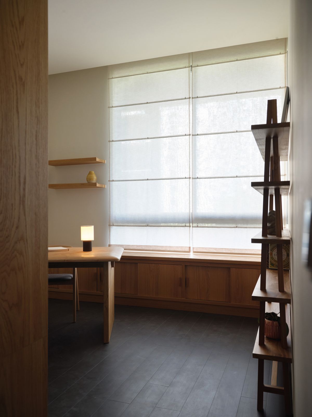 The study (right) and kitchen (left) both sport a moody ambience
