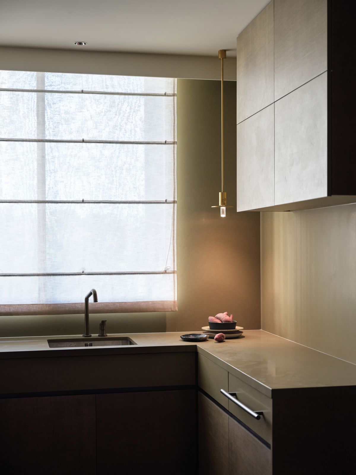 The study (right) and kitchen (left) both sport a moody ambience