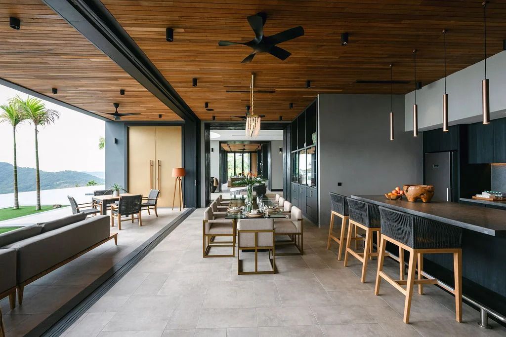 The open-plan living and dining area seamlessly melds with the outdoor expanse (Photo: Memories.my)