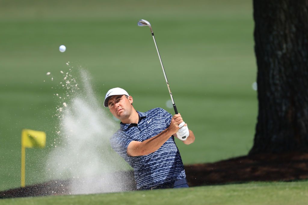 AUGUSTA, GEORGIA - APRIL 10: Scottie Scheffler plays a shot on the tournament practice area during the final round of the Masters at Augusta National Golf Club on April 10, 2022 in Augusta, Georgia. (Photo by David Cannon/Getty Images)