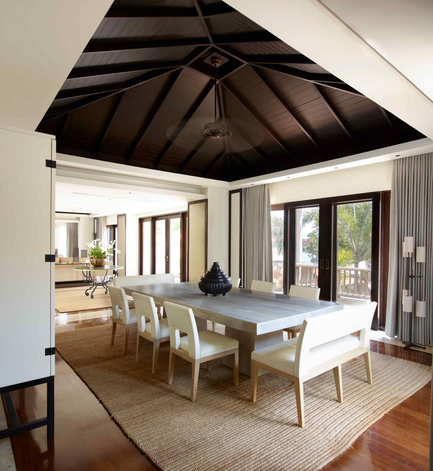 The dining area with a dark wood accent ceiling