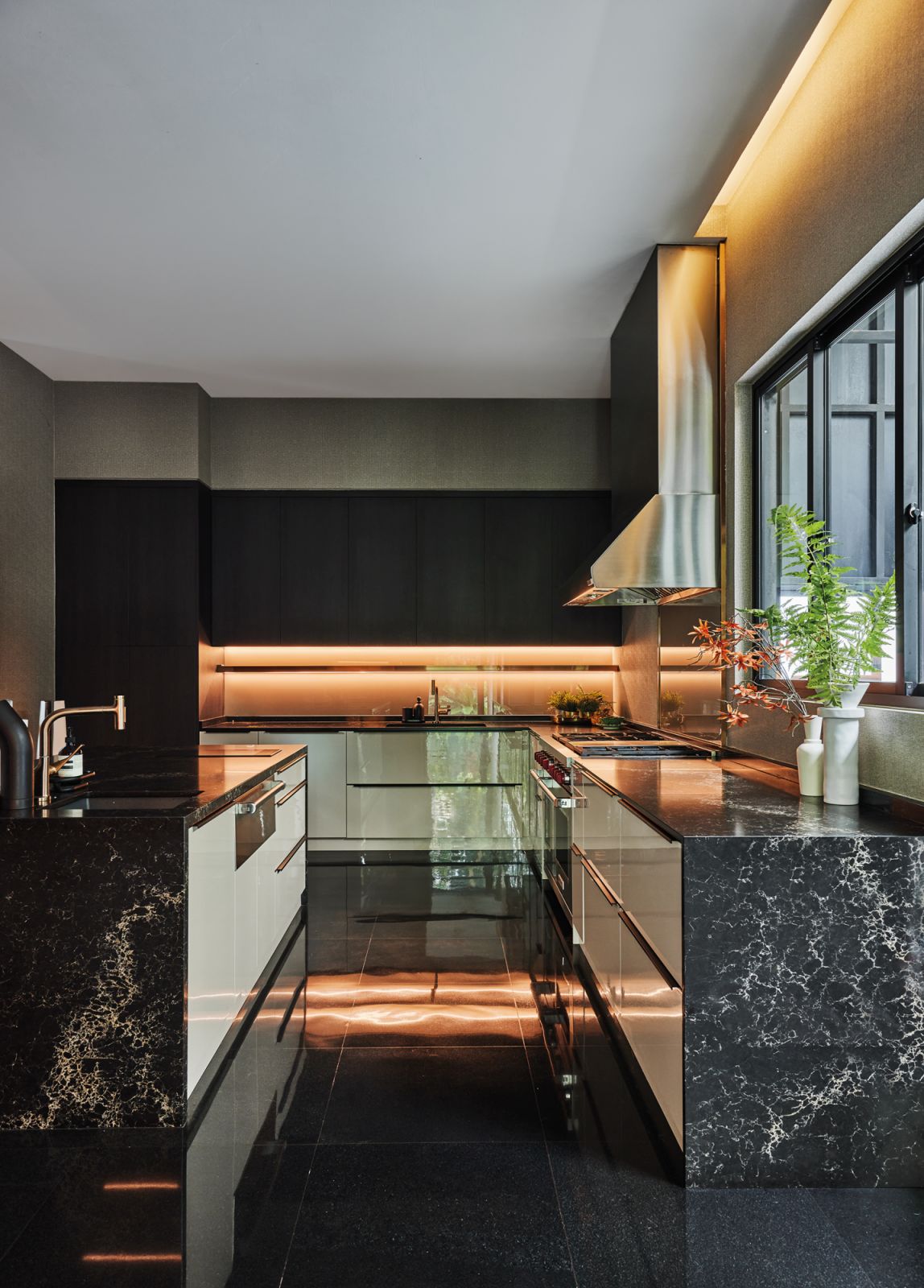 Relocating the wine cellar to the basement allowed the kitchen to house a breakfast counter