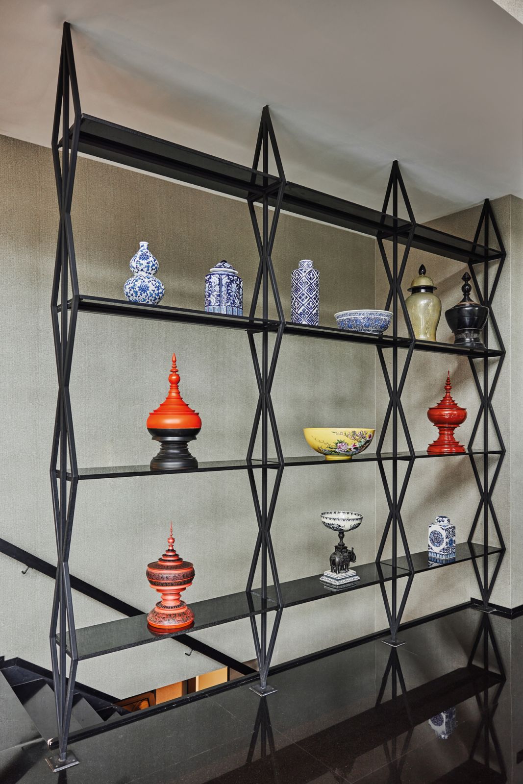 The designer updated these display shelves with dark stone and a matte-black finish