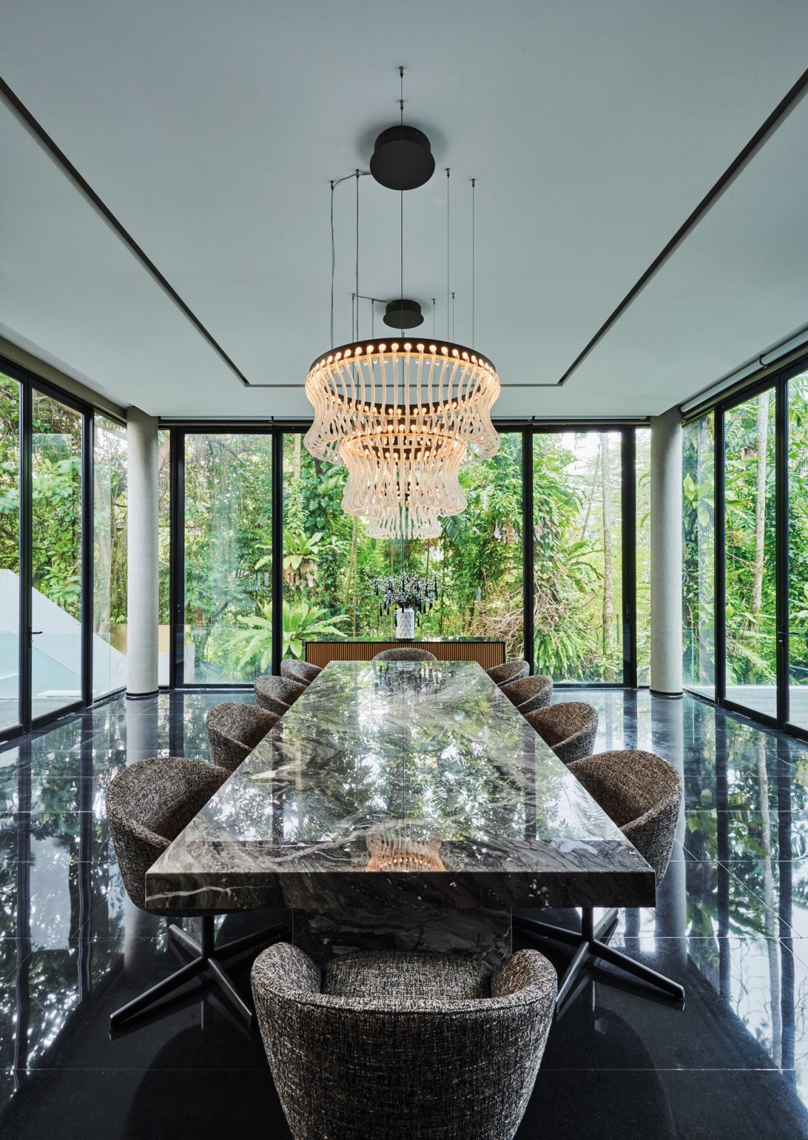 The majestic dining hall features the home’s original polished granite flooring, a bespoke marble table, Minotti dining chairs and two Crown chandeliers from Barovier & Toso