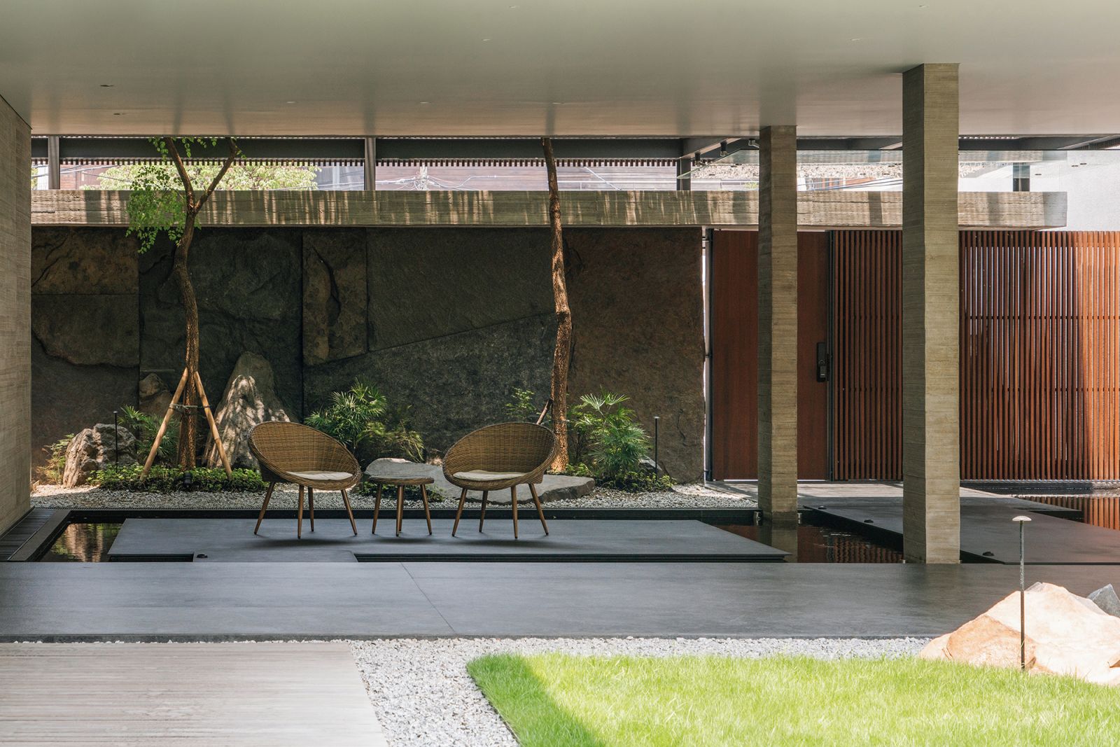 This outdoor sitting area is bordered by a cooling pond