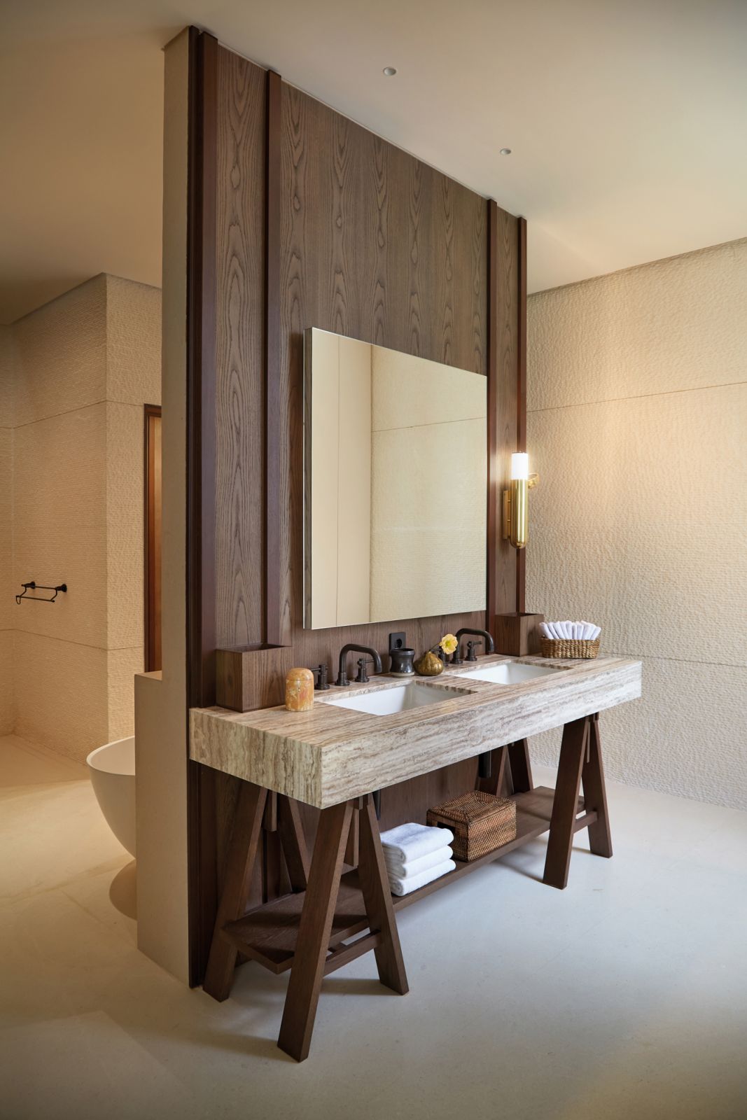 The master bathroom is furnished with a custom vanity incorporating a travertine countertop