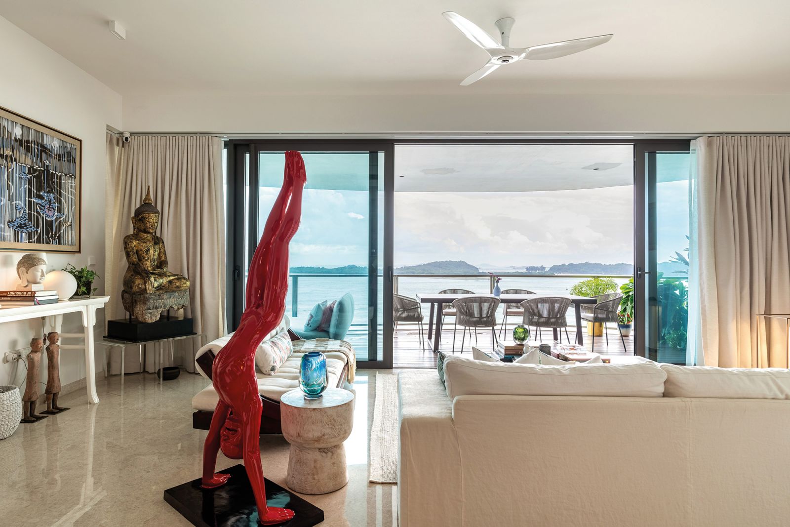 A sculpture by Chinese artist Chen Wen Ling makes a compelling statement in the living room with its bright red hue