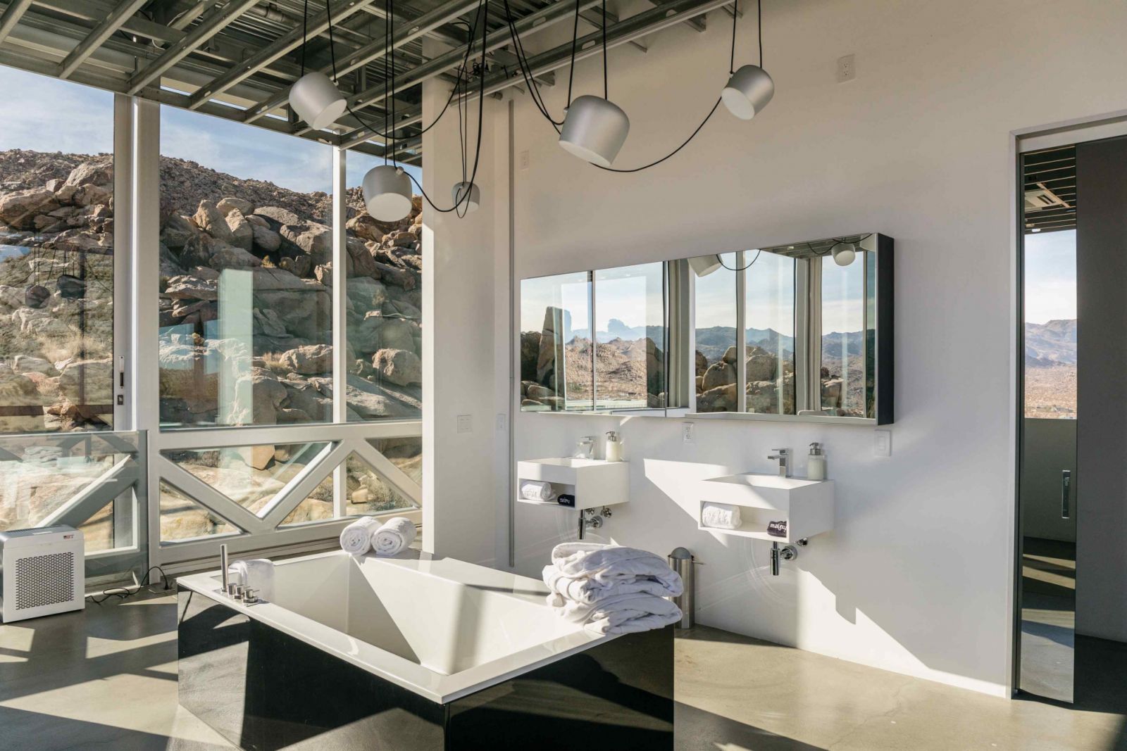The primary bath with a soaking tub, floating vanities and rain shower (Photo: Fieldtrip)