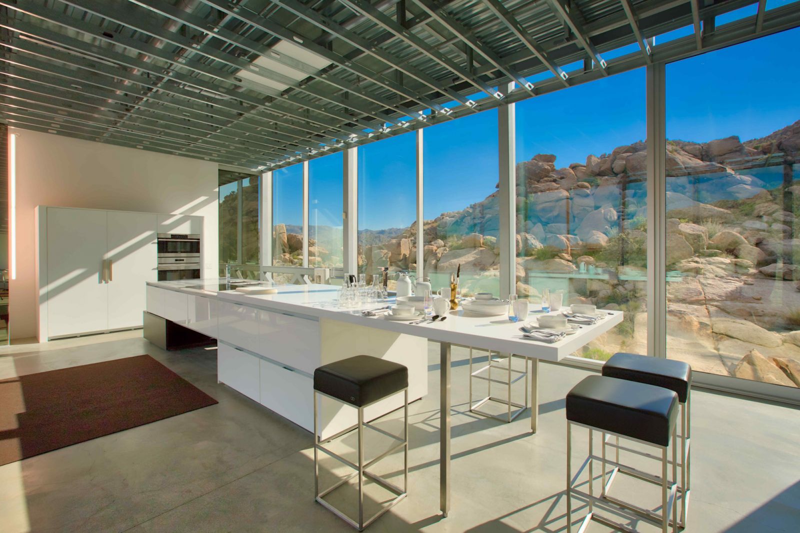 The expansive desert view through the reflective/refractive light filtering glass walls