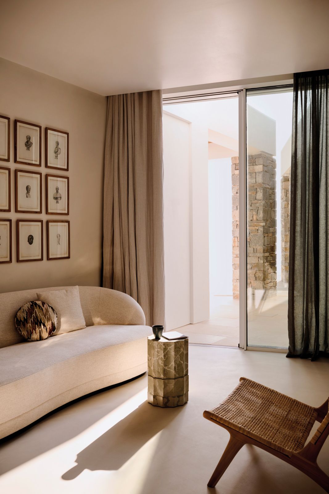 This cosy nook is furnished with a Hamilton Conte sofa, Domus Pompeii Fauno side table by Roberto Sironi and Pierre Frey curtains