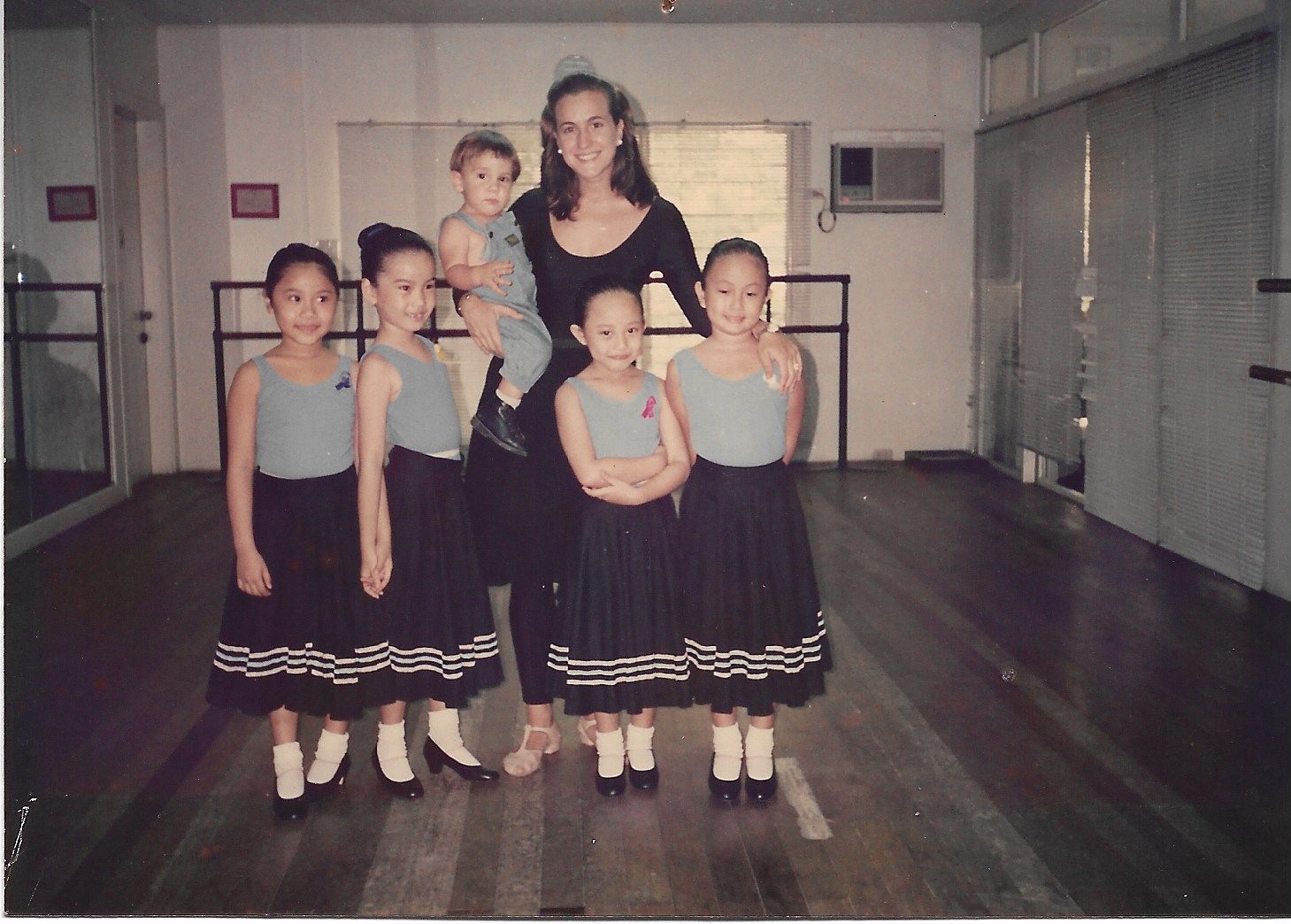 Elizalde with her students and son Paxti at her first dance studio on Estrella Street