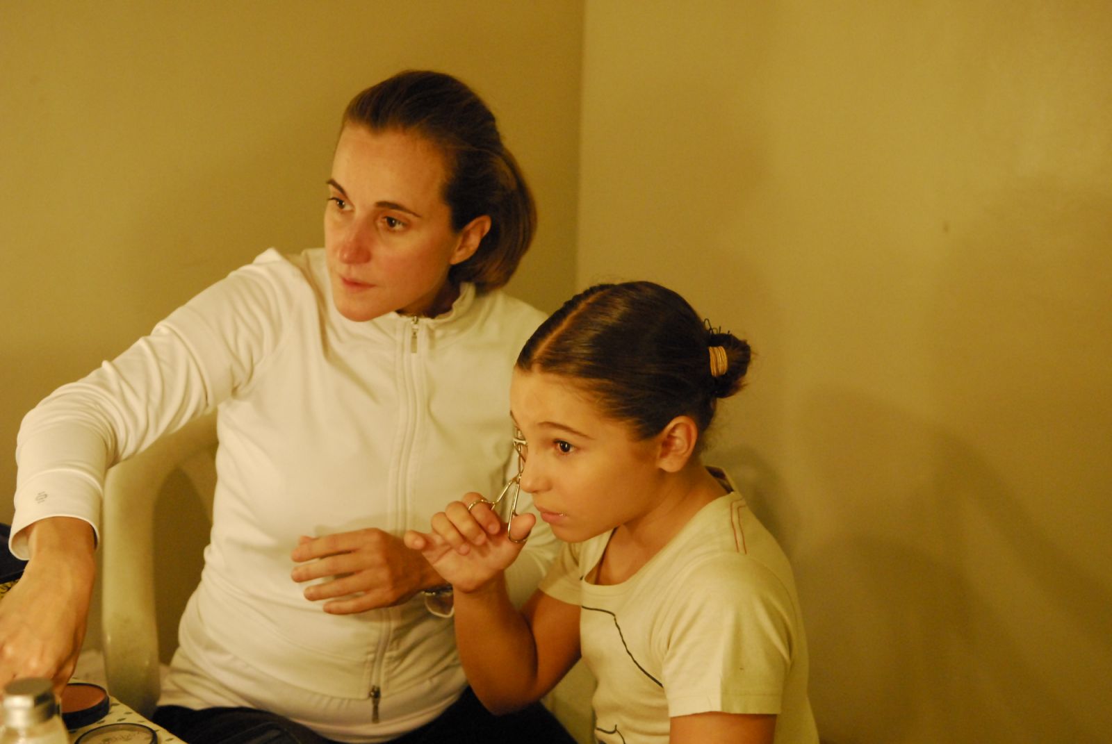 Sofia Zobel Elizalde helping a young student get ready before a performance