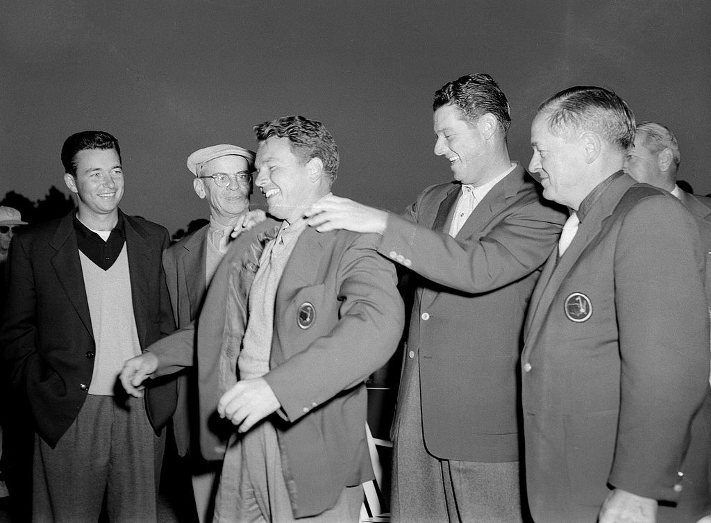AUGUSTA, GA - APRIL 1956: Ken Venturi, Clifford Roberts and Bobby Jones, far right, watch as Jack Burke, Jr. receives a Green Jacket from Cary Middlecoff during the 1956 Masters Tournament Presentation Ceremony at Augusta National Golf Club in April 1956 in Augusta, Georgia. (Photo by Augusta National/Getty Images)